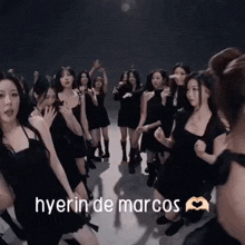 a group of women are dancing in a dark room .