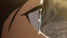 a close up of a person 's eye with a tear running down it