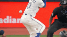 a baseball player with the number 10 on his jersey is swinging at a ball