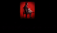a man sits in a chair in front of a screen that says agr