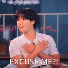 a man in a white shirt is clapping his hands and says " excuse me "