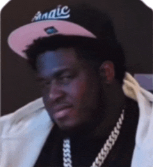 a man wearing a pink hat that says magic on it