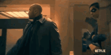 a man in a suit and tie is standing next to a woman in a mask in a hallway .