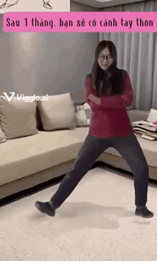 a woman is dancing in a living room with her arms crossed .