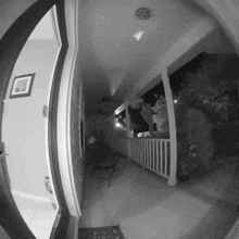 a black and white photo of a porch with a smoke detector on the ceiling