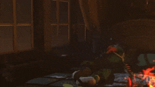 a person is laying on the floor in a dark room with a fire .