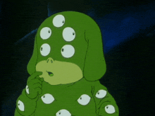 a green cartoon character with many eyes on his face