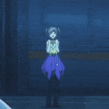 a girl in a yellow shirt and a purple skirt is dancing in a dark room