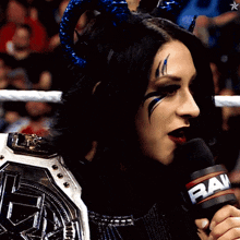 a woman wearing horns and a raw microphone