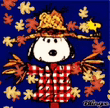 snoopy is wearing a scarecrow costume with a straw hat