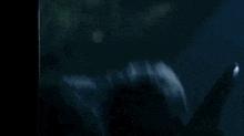 a close up of a waterfall in the dark with a light coming out of it .