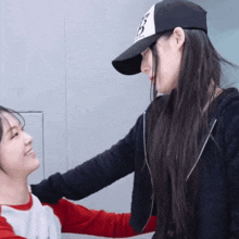 a girl wearing a baseball cap with the letter b on it