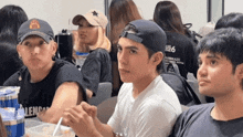 a group of people sitting at a table with one wearing a shirt that says blend