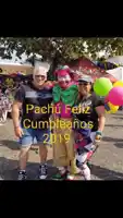 a man and two women pose with a clown that says pachu feliz cumpleanos 2019 on the bottom