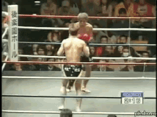 two men are fighting in a boxing ring with a sign that says round 3 2:16