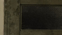 a wolf is peeking out of a doorway .
