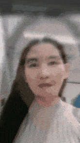 a close up of a woman 's face with a blurred background .