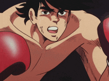 a shirtless boxer wearing red boxing gloves
