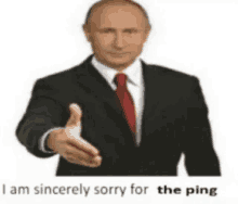 a man in a suit and tie is reaching out his hand to shake someone .