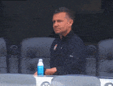 a man wearing a black jacket with a canadian logo on it