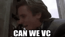 a man is talking on a phone and the words `` can we vc '' are written on the screen .