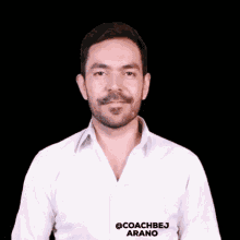 a man in a white shirt with the name coachbej arano on it