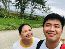 a man and a woman are smiling for a picture