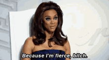 a woman is sitting in a chair and saying `` because i 'm fierce , bitch ''