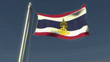 a red white and blue flag with a yellow anchor on it