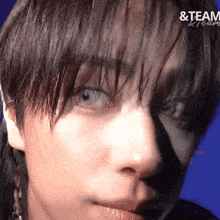 a close up of a person 's face with the words & team written on the bottom right