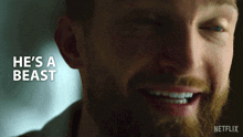 a close up of a man 's face with the words he 's a beast behind him