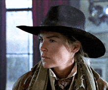 a woman wearing a cowboy hat and scarf