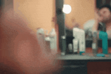 a blurry picture of a woman looking at herself in the mirror
