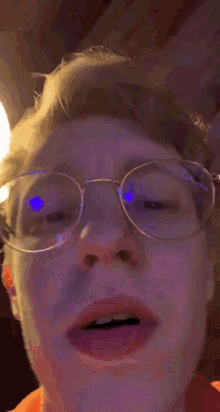 a close up of a person 's lips with a purple and yellow background