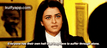 a woman in a suit says everyone has their own hell that they have to suffer through alone .
