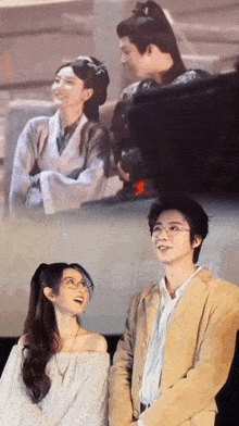 a man and a woman are standing next to each other and looking up at the sky .