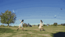 a girl in a white dress is dancing in a park