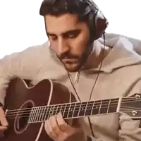 a man wearing headphones plays a guitar