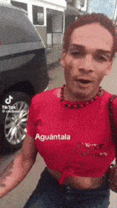 a man is wearing a red shirt that says aguantala on it