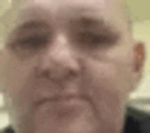 a close up of a man 's face with a serious expression .
