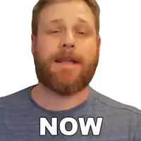 a man with a beard wearing a blue shirt with the word now on it