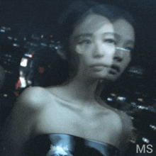a blurry picture of a woman with the letters ms on the bottom right