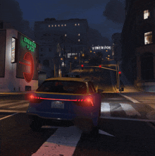 a car is driving down a street with a vinewood plaza sign in the background