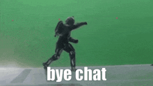 a robot is dancing in front of a green screen with the words `` bye chat '' written below it .