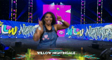 a woman on a stage with the name willow nightingale written on it