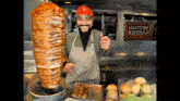 a man is standing in front of a sign that says mastster kebbap