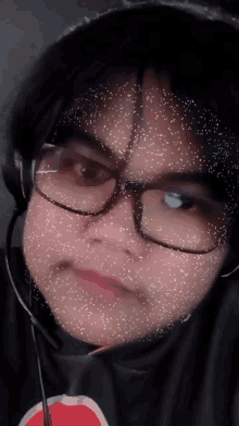 a close up of a person wearing glasses and a headphone