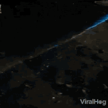 shining wave viralhog shing water blue water bioluminescent water