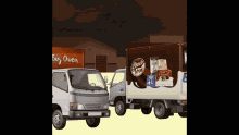 two trucks are parked in front of a big oven building