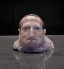 a statue of a man 's head with a sad face